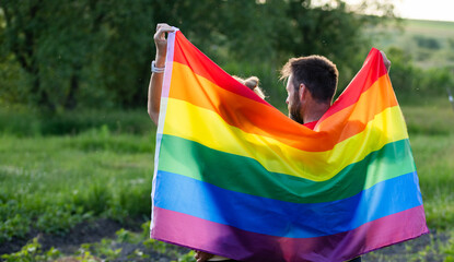 couple holding rainbow flag for pride month