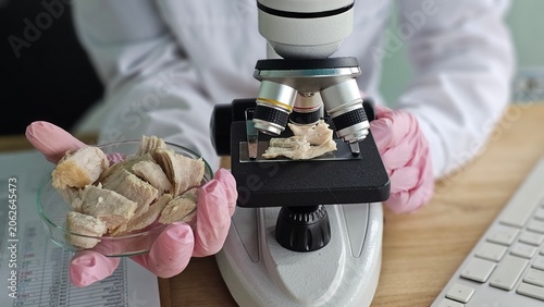 Cuadro en lienzo A scientist uses a microscope to examine a meat sample