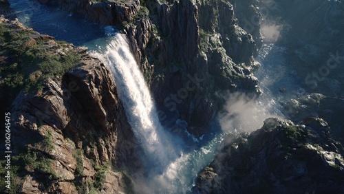 Majestic waterfall cascading down rugged rocky cliffside surrounded by lush greenery