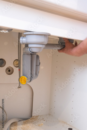 Under-sink plumbing installation with trap and drain connection