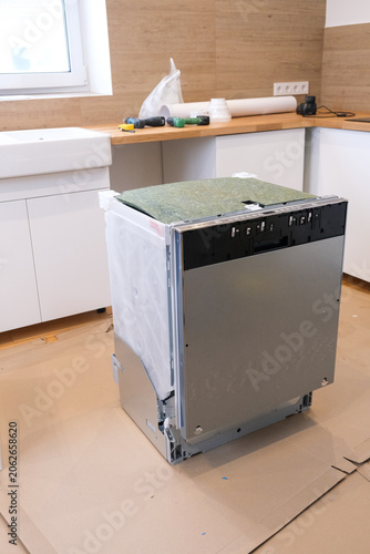 Stainless steel dishwasher uninstalled in kitchen renovation