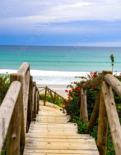 Wooden pathway to turquoise ocean