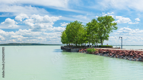 Hungary, Lake Balaton, a marina for small boats on the shore with a view of the lake and the other shore on a sunny summer day.