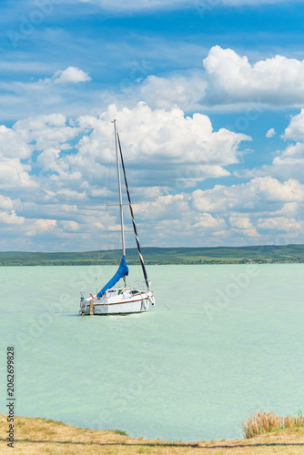 Hungary, Lake Balaton, sailboat moored on the water, view of the other side of the lake on a sunny summer day.