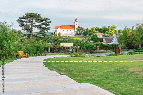 Hungary, Tihany, Benedictine monastery atop a hill in a tourist town. Walking paths and a green recreational area.
