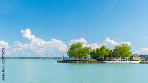 Hungary, Lake Balaton, a marina for small boats on the shore with a view of the lake and the other shore on a sunny summer day.