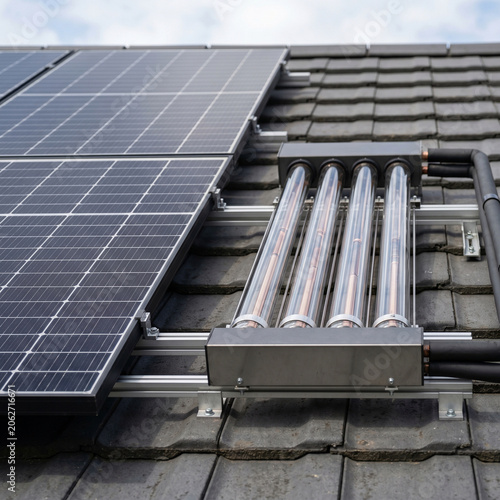 Extreme close-up of a house roof with a photovoltaic system and solar thermal collectors, minimalist sustainable energy concept