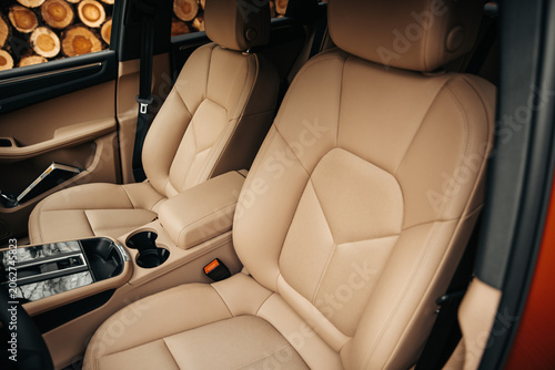 Canvastavla View of the front passenger and driver seats in a modern car interior with luxury beige leather upholstery