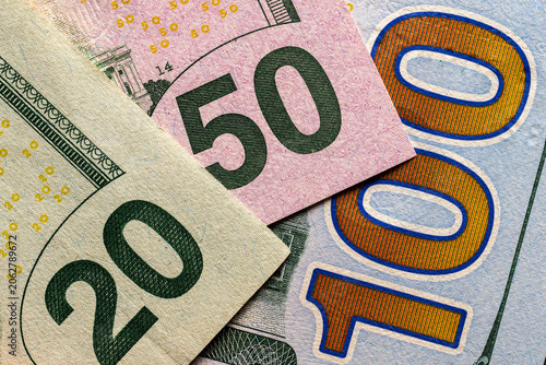 Foto Macro image of overlapping US dollar bills showing large 20, 50 and 100 denomination numbers