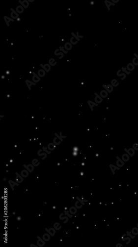 Real snow snowing on black background in cold winter season in vertical