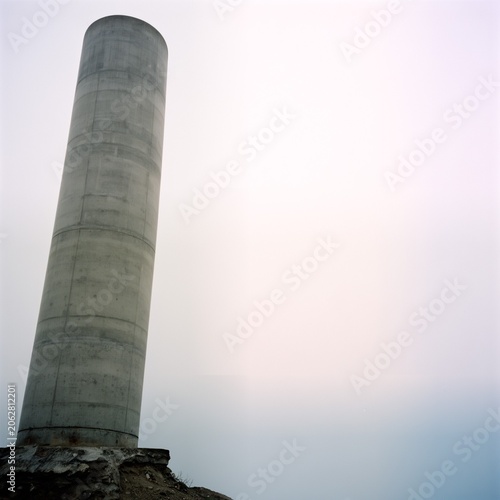Brutalist Concrete Pillar Against Overcast Sky [1x1]