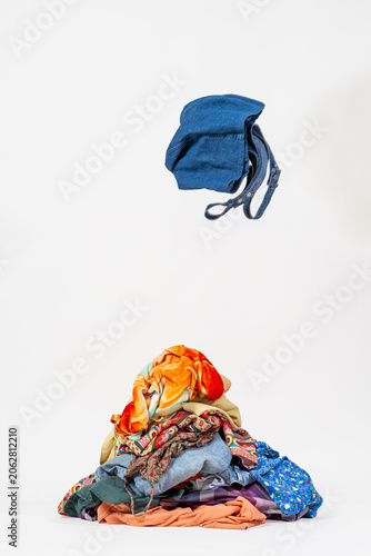 Pile of unfolded laundry against white background