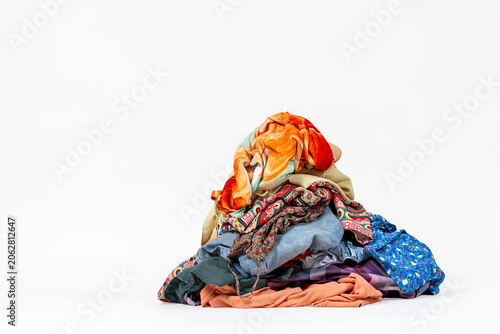 Pile of unfolded laundry against white background