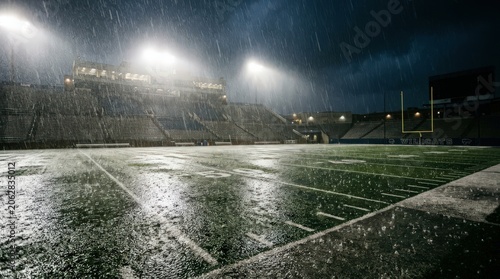 empty sports field at nighttime raining.