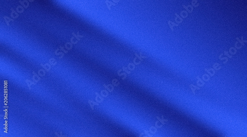 Aerial view of a blue fabric with folds and creases on a plain surface