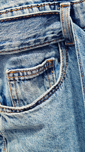 Close-up of a pocket on blue denim jeans overall