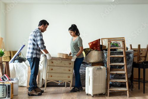 Photography Couple moving furniture together photo