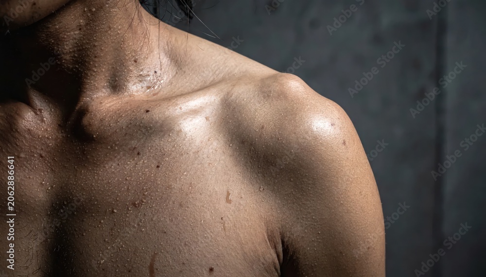 Naklejka premium Close-up of a Sweaty Mans Shoulder and Neck After Intense Workout.