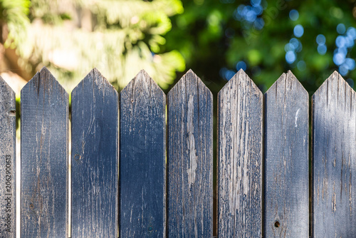 A close up of a wooden fence with sharp tops.