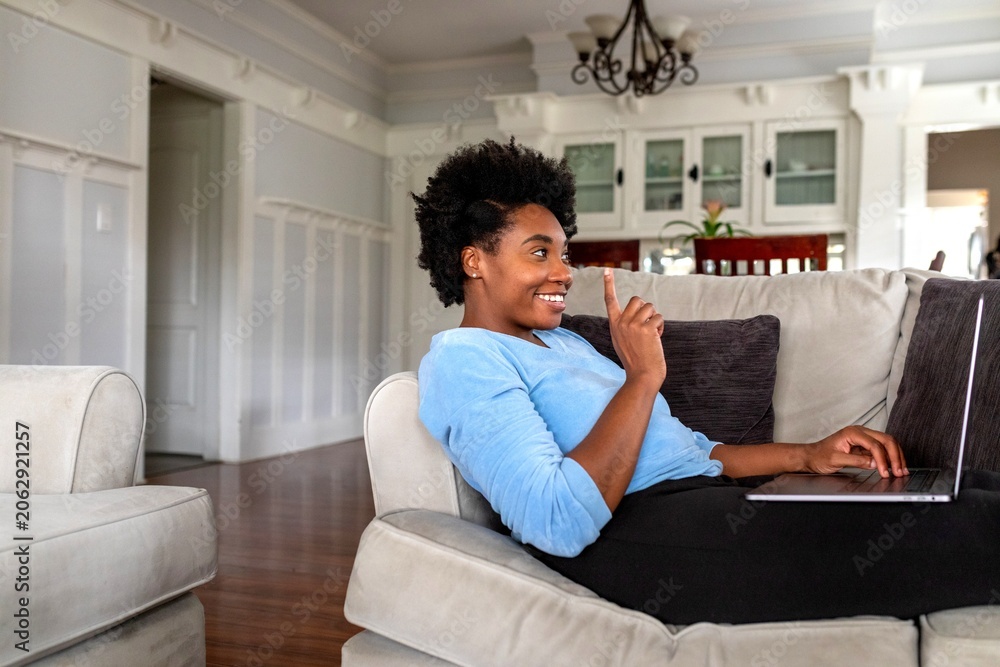 Fototapeta premium Relaxed woman using laptop indoors.