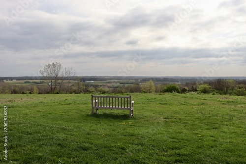 The empty wood bench in the country field.