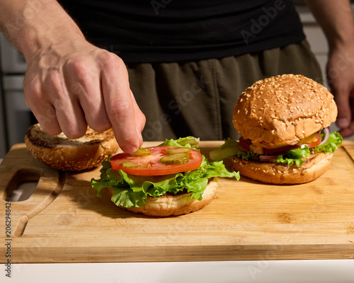 A man cooks burgers at home