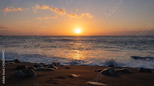 Atlantic Ocean sunset at the volcanic black sand beach of Ajuy, Fuerteventura