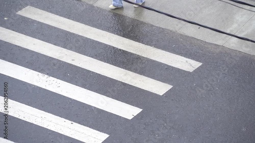 people cross the road in a downpour