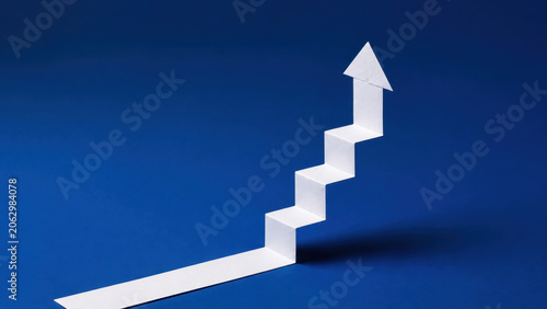 White Paper Staircase Forming Upward Arrow on Blue Background