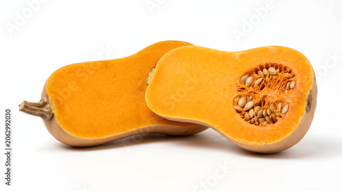 Fresh organic butternut squash halves showing bright orange flesh and seeds isolated on a white background for healthy culinary cooking ingredients