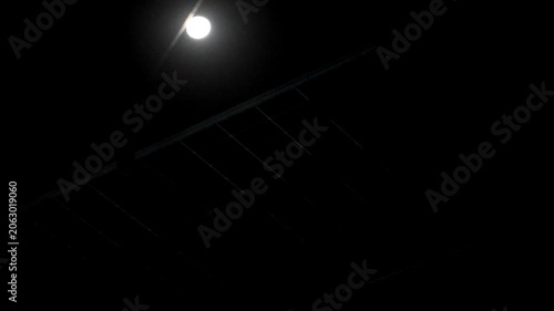 Solar panels at night illuminated under a bright glowing full moon sky 180fps Captured in Cinematic High Detail Footage