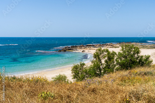 Scenic Mediterranean coastline featuring turquoise waters, unique kurkar cliffs, and diverse marine life, celebrated for its natural beauty and relaxing seaside ambiance.