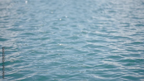 Ocean Waves Surface: A calm ocean surface with gentle waves reflecting the light, creating a serene and peaceful aquatic background.