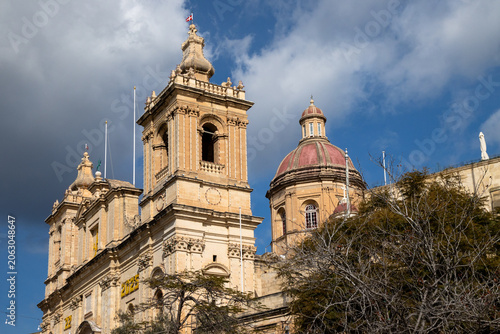 Canvastavla Parish Church of St Lawrence with ornate bell towers and red dome against dramat