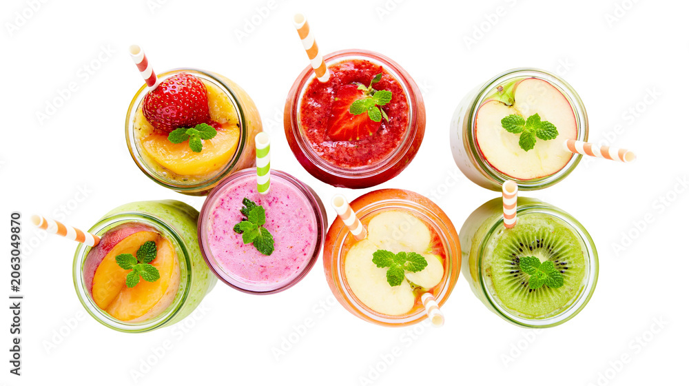 Naklejka premium Assortment of colorful fruit smoothies in glass jars with mint leaves and straws