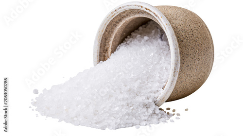 Coarse sea salt spilling from ceramic pot