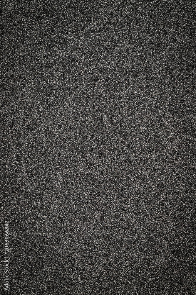 Fototapeta premium Black asphalt surface shows texture and detail in urban setting during daylight hours
