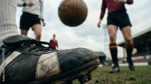 Close-Up of Vintage Soccer Cleat and Leather Ball