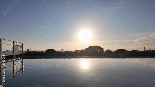 sunset at a rooftop pool in kuta on bali