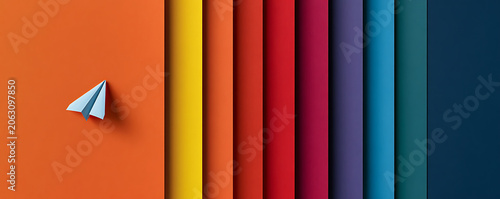 Conceptual paper airplane flying across a vibrant spectrum of layered colors, representing innovation and aspirations