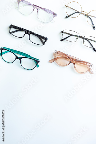 Glasses for vision on a white background in optical store. Vision test concept, stylish glasses concept