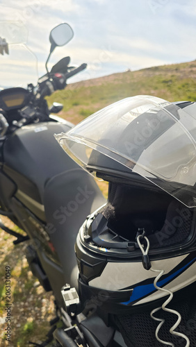 A motorcycle parked on a ledge at the top of a mountain in northern Portugal. Motorcycle travel ideas, practical problem-solving, and mobility for adventure.