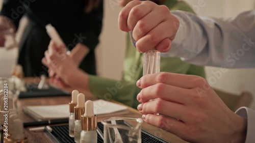 Caucasian woman closing glass perfume spray bottle during master class workshop. Footage is ideal for beauty industry promotions, DIY cosmetics tutorials, and artisanal craft marketing