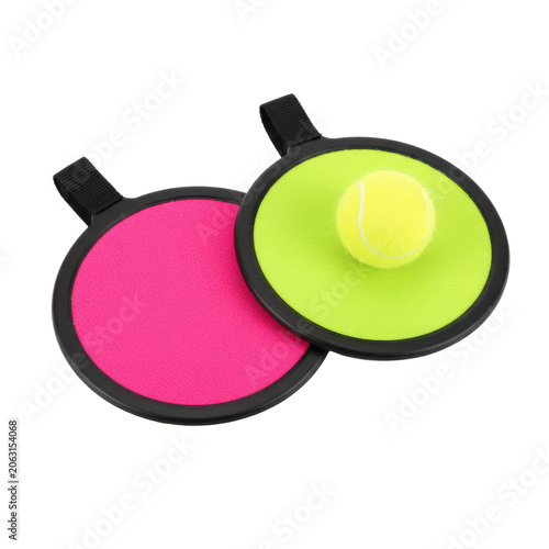 A neon pink and lime green hook loop paddle set with a fuzzy yellow ball on a white background showcasing micro textures nostalgic summer play atmosphere