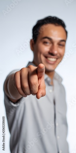 Smiling Person Pointing Finger Toward Empty Direction for Advertising, Marketing and Copy Space. High-quality professional photograph featuring a happy smiling person pointing with their finger toward