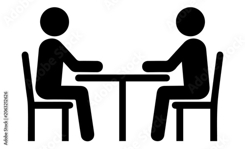 Two people sitting at a table icon meeting silhouette with business communication collaboration