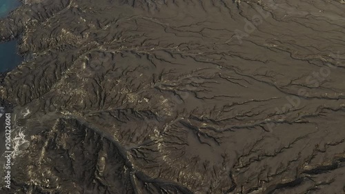Aerial Over Vast Volcanic Ash Plain With Erosion Patterns