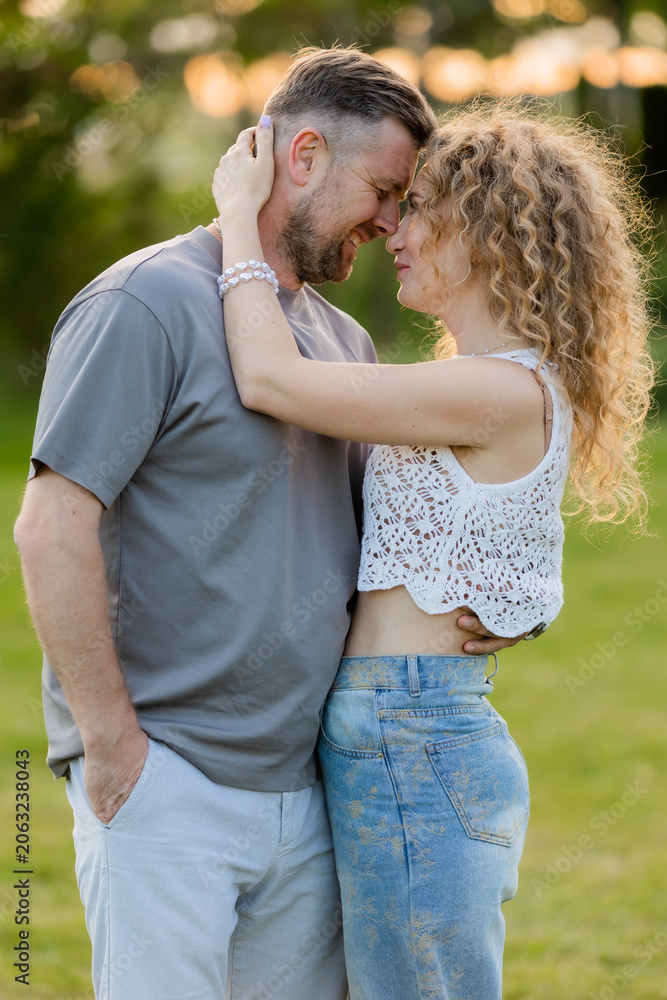 Fototapeta premium couple of man and woman hugging in the summer in a city park