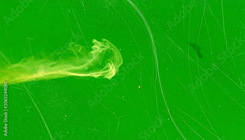 A green background with a yellow streak and scratches