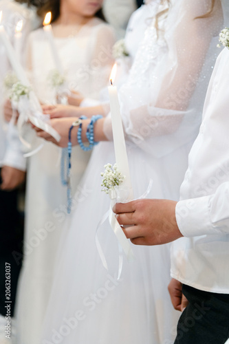 Communion. Children hold candles at a ceremony during a special event in a community center